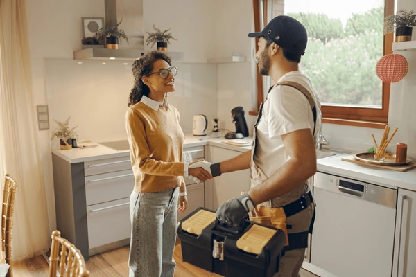 professional-repairman-uniform-shaking-hands-woman-600nw-2410128681